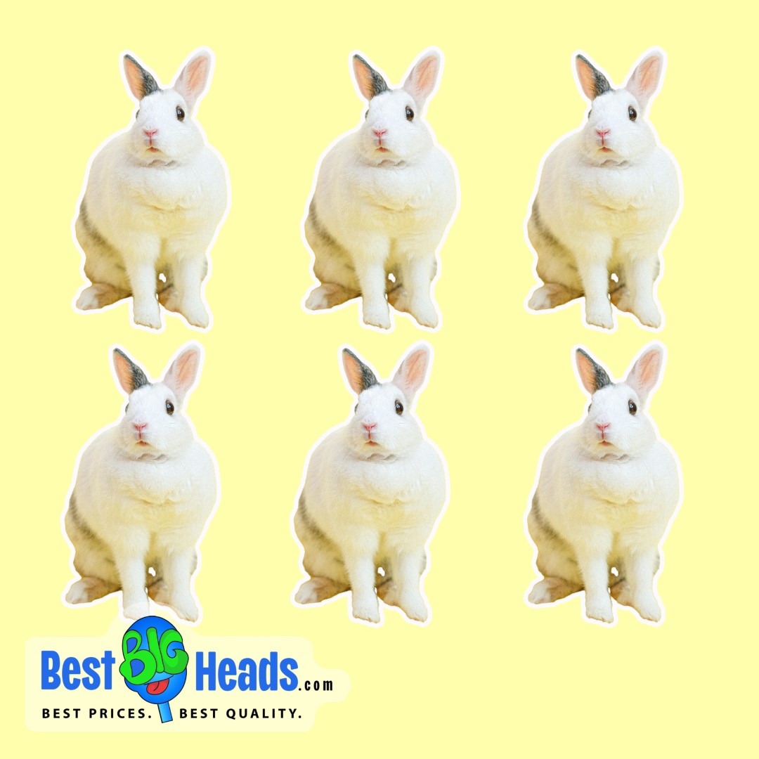 Adorable white bunny with black spots sitting on cutout stickers against a yellow background.